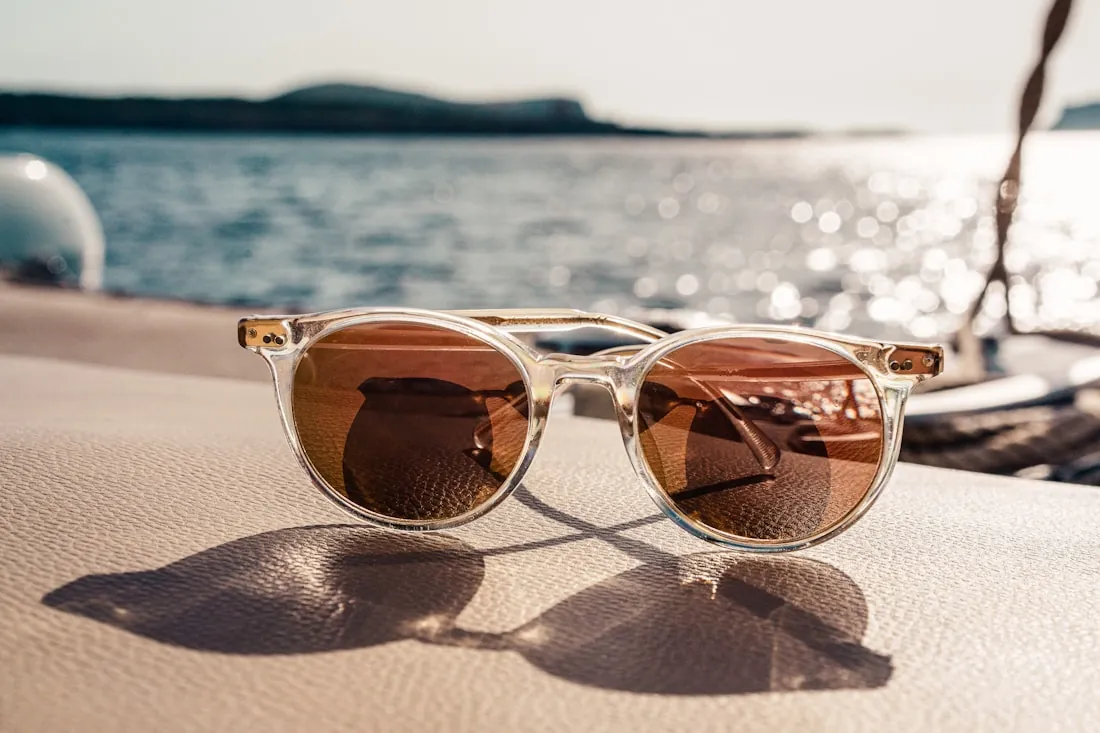 Retro white-framed sunglasses with brown lenses
