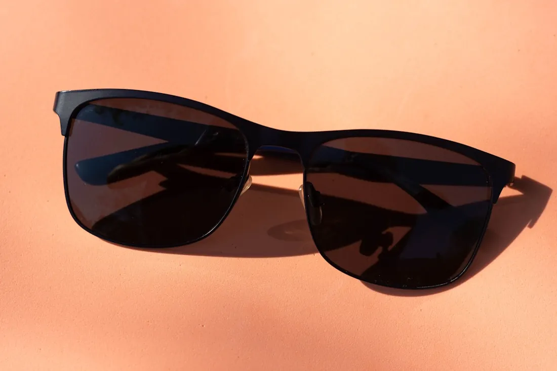 Black acetate sunglasses on a white table