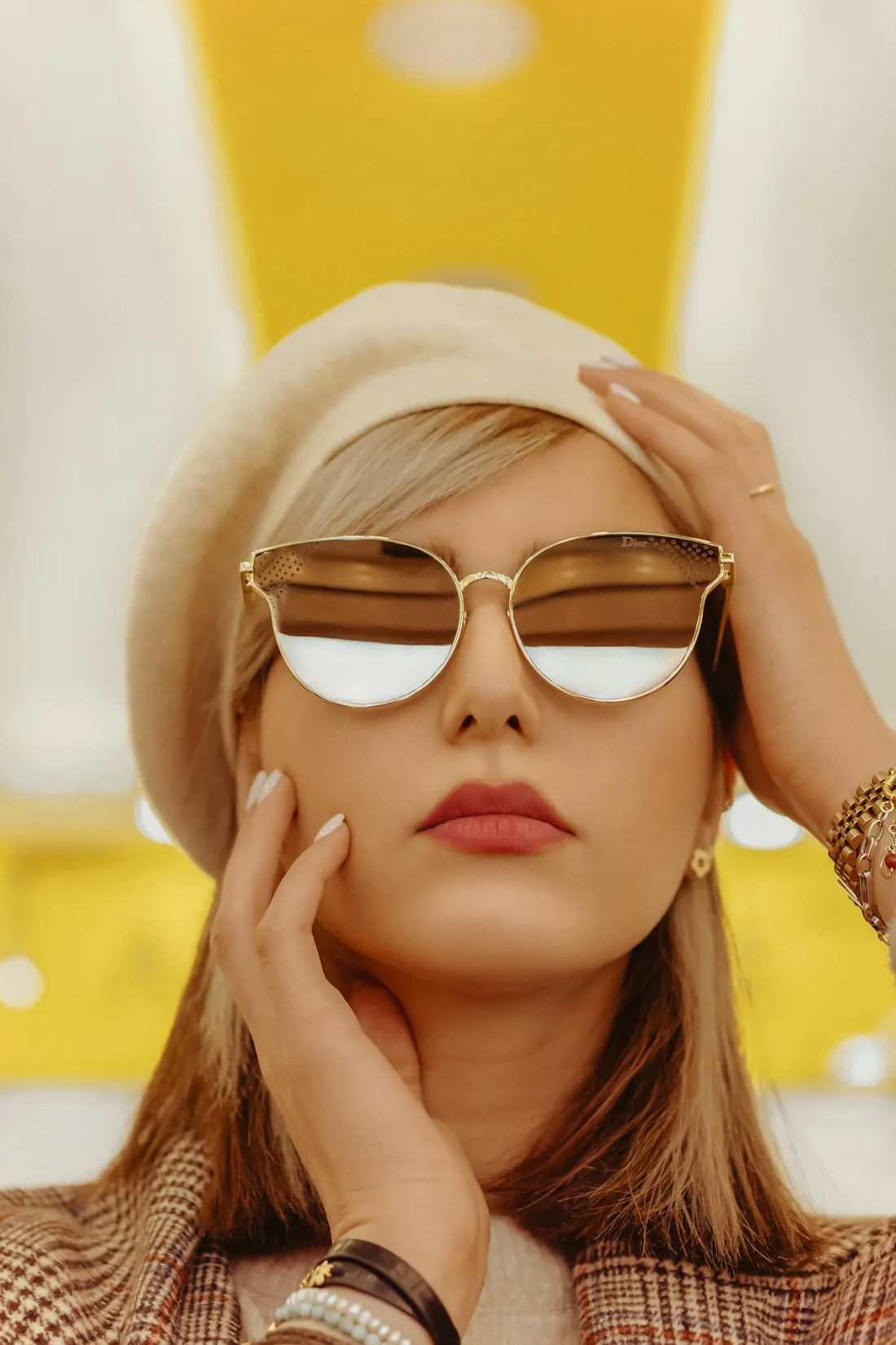 Woman wearing gold-framed aviator sunglasses