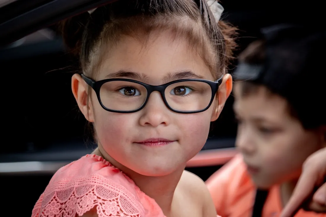 Girl smiling in black-framed glasses