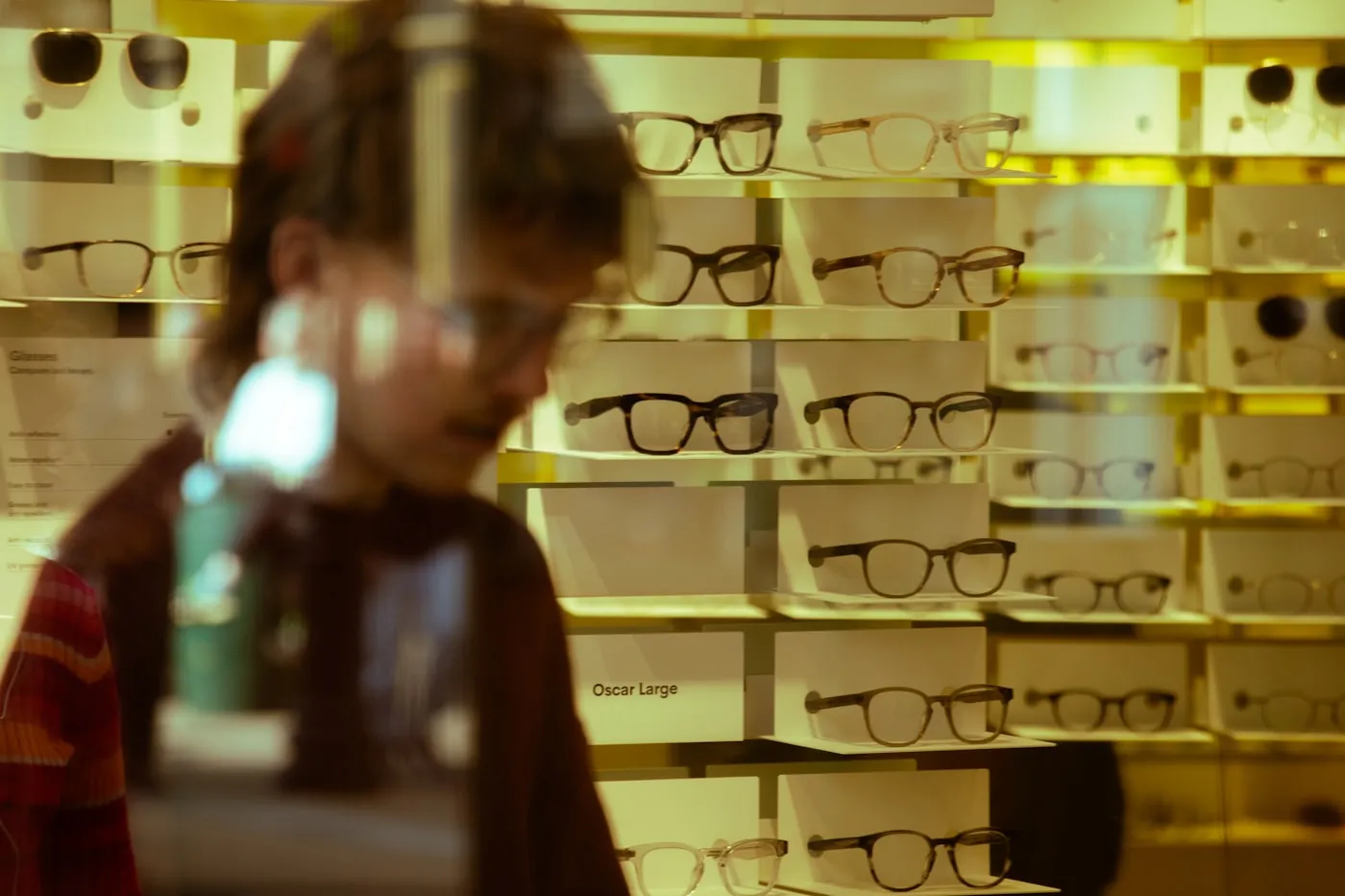 Person browsing frames at a boutique display